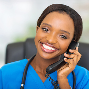 A young ethnic nurse on the phone. 